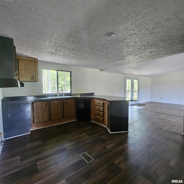 kitchen featuring black dishwasher, a textured ceiling, sink, and dark hardwood / wood-style floors