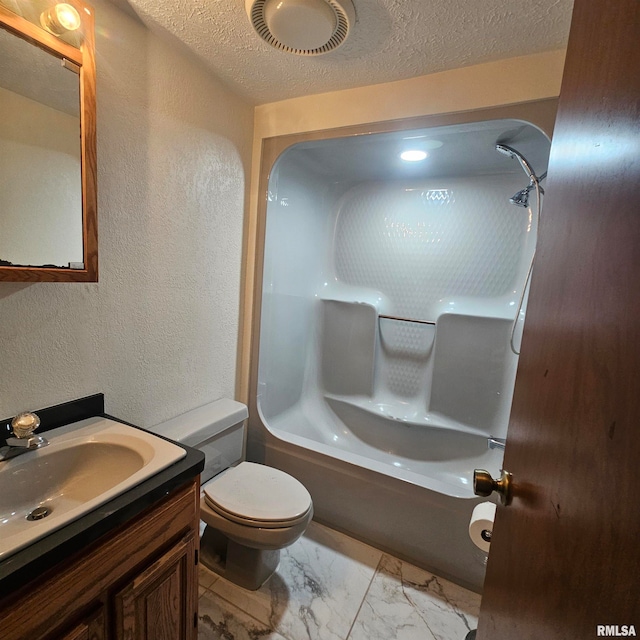 full bathroom featuring vanity, toilet, shower / bathing tub combination, and a textured ceiling