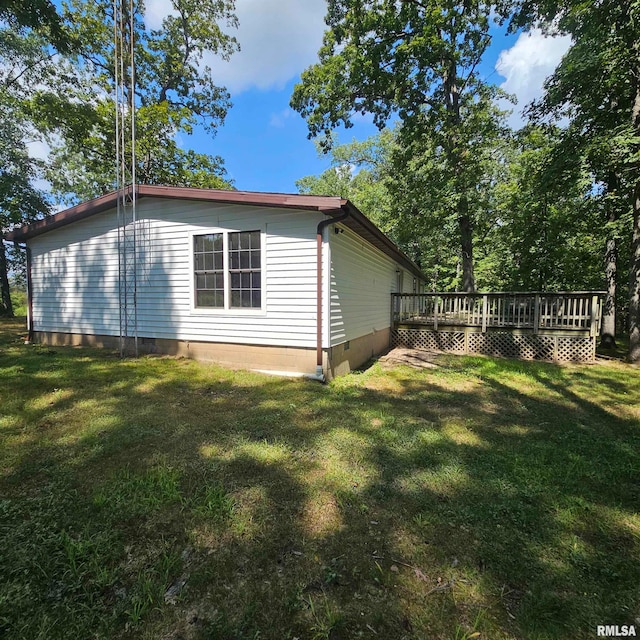 view of home's exterior with a yard and a deck