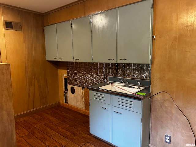 kitchen featuring backsplash, sink, and dark hardwood / wood-style floors