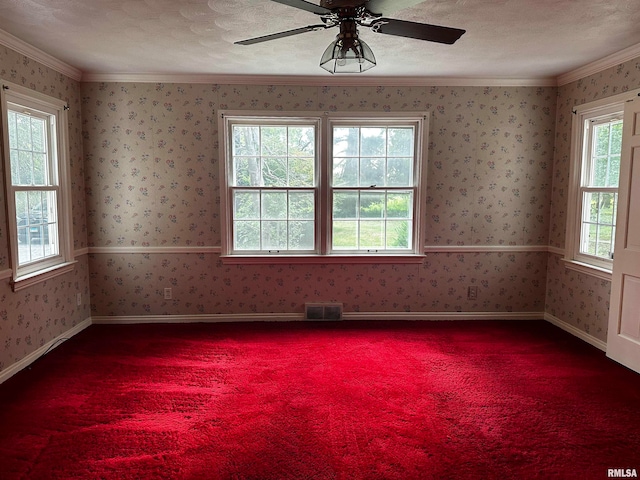 empty room with ceiling fan, a textured ceiling, ornamental molding, and carpet