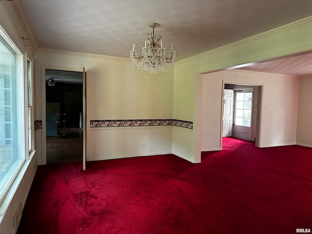 unfurnished room featuring carpet, crown molding, and a chandelier