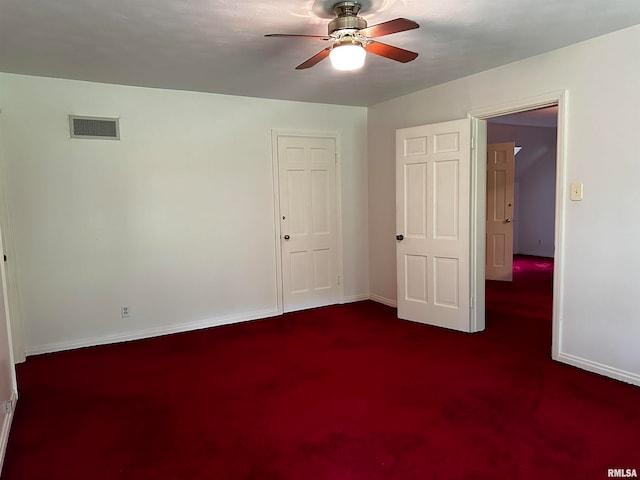 empty room with ceiling fan and carpet floors