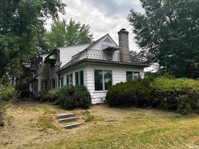 rear view of house with a yard