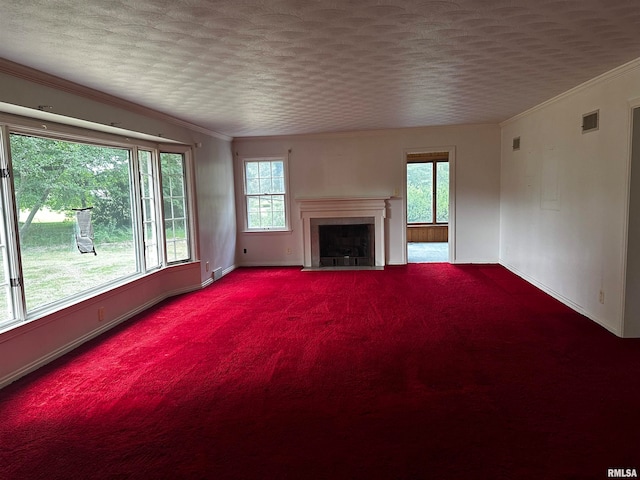 unfurnished living room featuring crown molding, carpet flooring, and a tiled fireplace