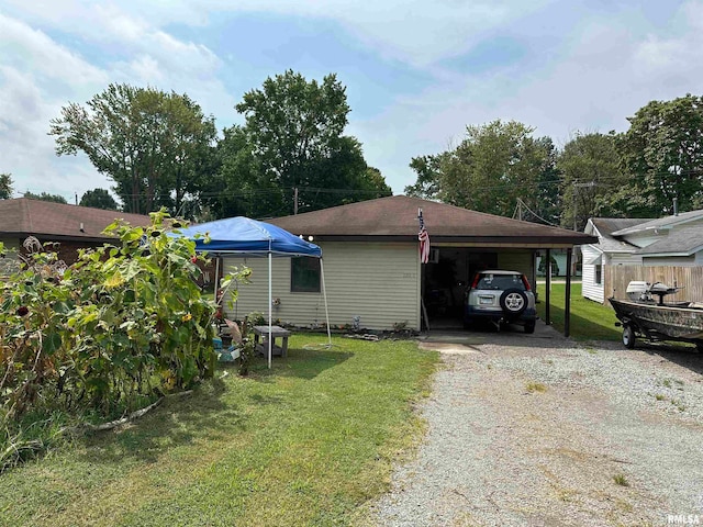 exterior space featuring a yard and a carport