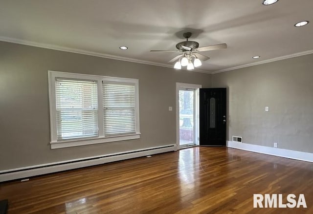 empty room with ceiling fan, baseboard heating, ornamental molding, and wood-type flooring