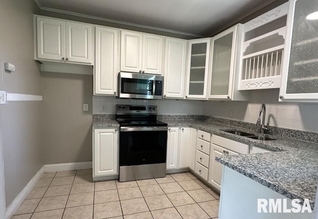 kitchen featuring sink, white cabinets, light tile patterned flooring, and stainless steel appliances