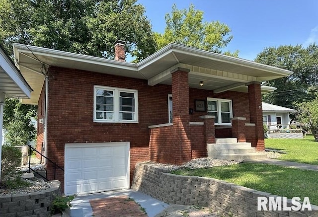 view of front of house with a garage and a front yard