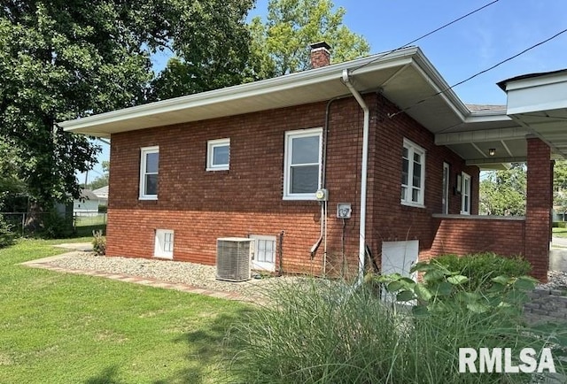 view of side of home with central air condition unit and a lawn