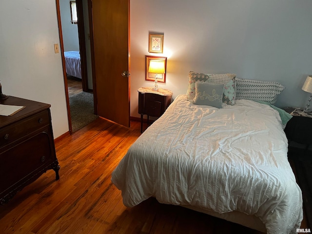 bedroom with dark wood-type flooring