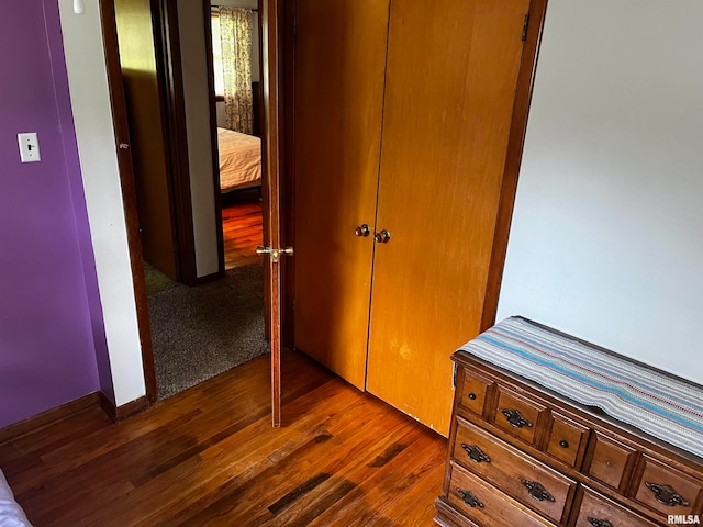 bedroom with a closet and dark hardwood / wood-style flooring