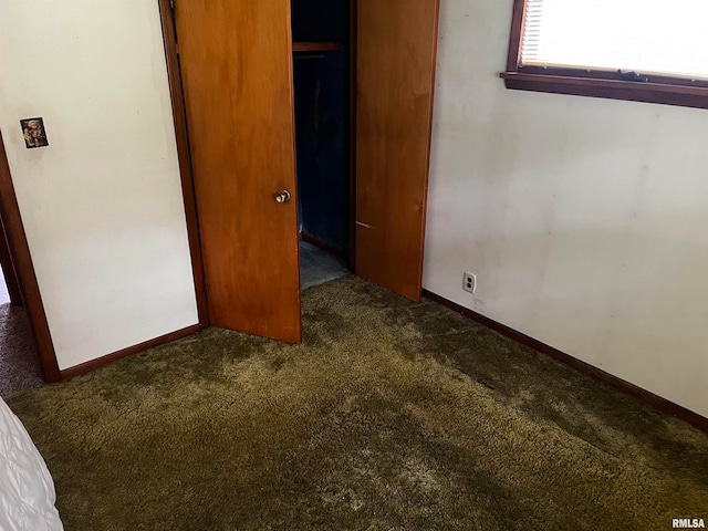 unfurnished bedroom with carpet and a closet