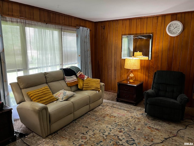 living room featuring carpet and wooden walls