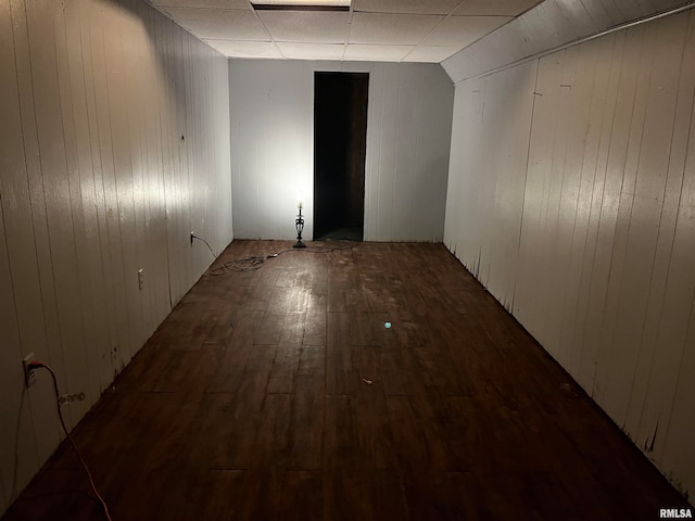 spare room featuring a drop ceiling, lofted ceiling, and hardwood / wood-style flooring