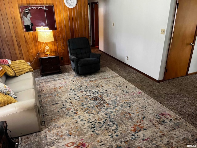 carpeted living room with wooden walls