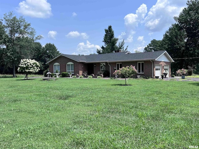 single story home featuring an attached garage, brick siding, and a front yard