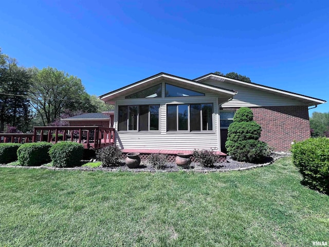 view of side of home with a yard