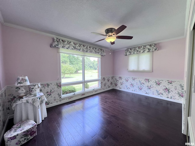 unfurnished room featuring dark wood-style floors, crown molding, a textured ceiling, and wallpapered walls