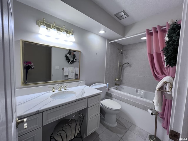 full bathroom featuring visible vents, toilet, tile patterned floors, tiled shower / bath, and vanity