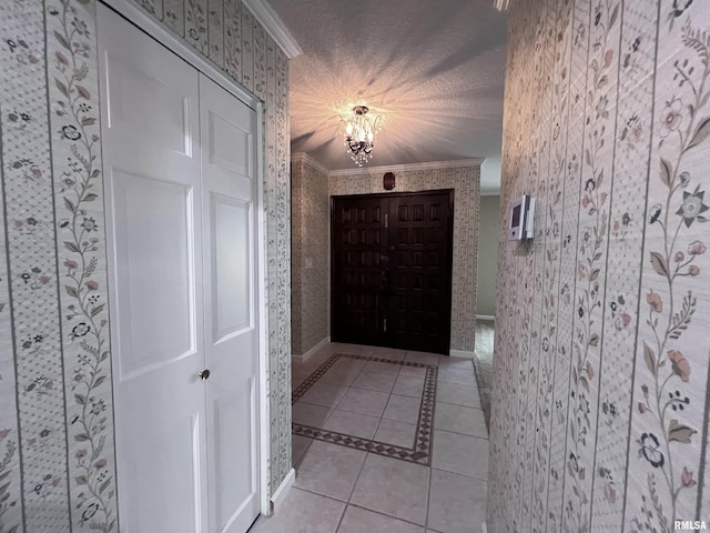 interior space with wallpapered walls, light tile patterned floors, and ornamental molding