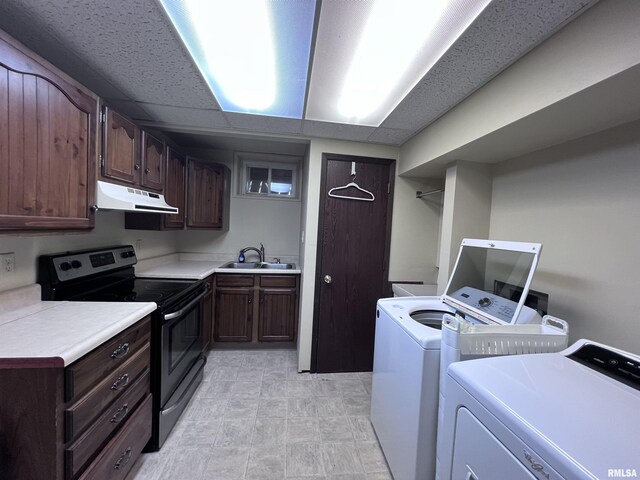 washroom with a sink, laundry area, and washer and dryer