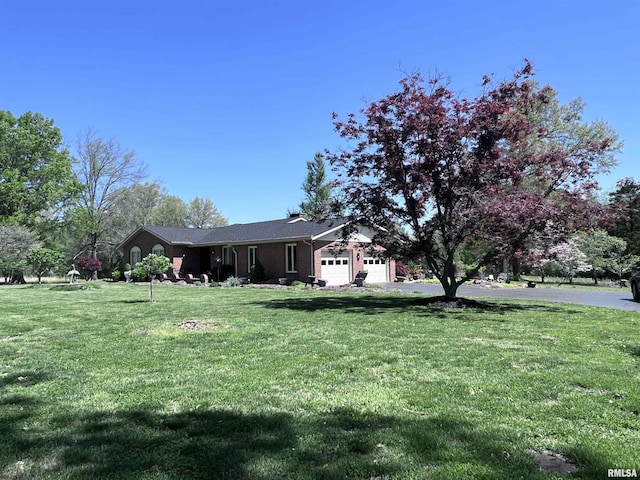 exterior space with aphalt driveway and an attached garage