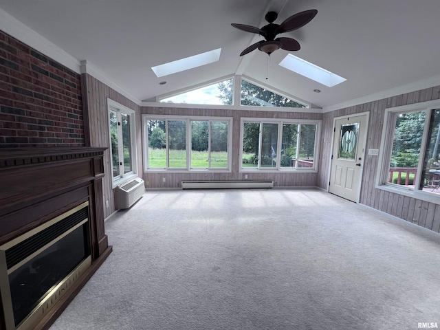 unfurnished sunroom featuring vaulted ceiling with skylight, baseboard heating, a wall mounted air conditioner, and a ceiling fan