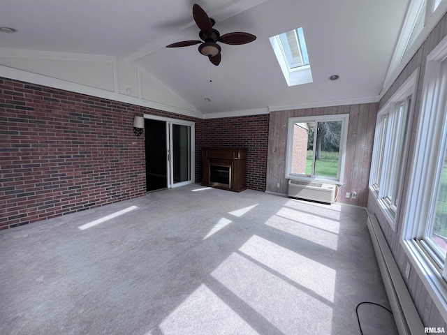 unfurnished living room with lofted ceiling with skylight, brick wall, carpet, an AC wall unit, and a fireplace