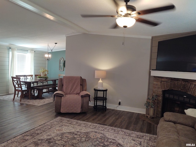 living room with ceiling fan, wood-type flooring, and ornamental molding