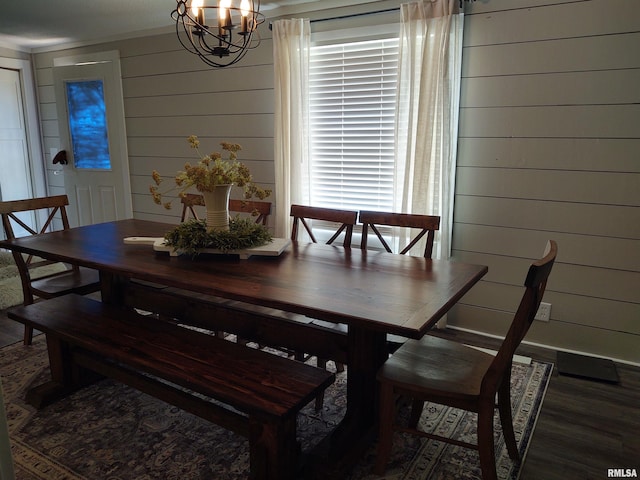 dining area with an inviting chandelier and wood-type flooring