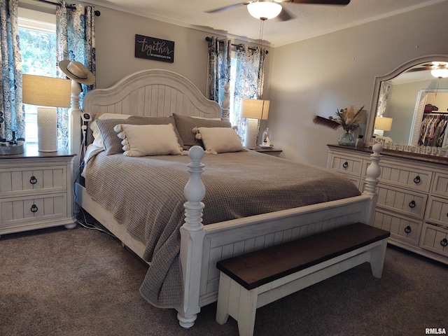 bedroom with ceiling fan and dark carpet