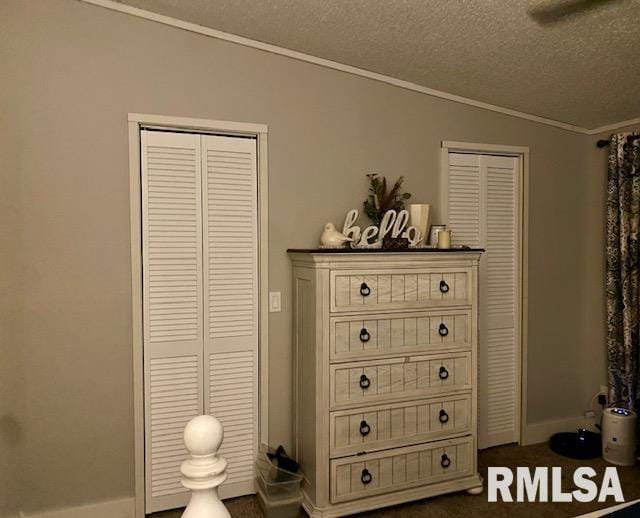 bedroom featuring vaulted ceiling, a textured ceiling, and ornamental molding