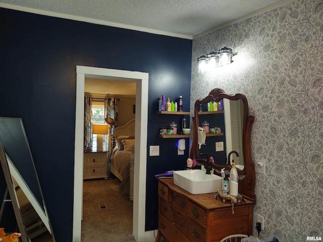 bathroom with a textured ceiling and vanity