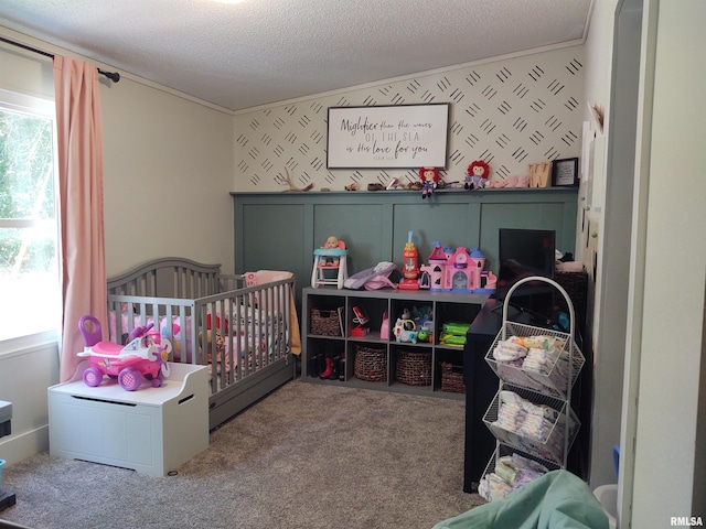 carpeted bedroom with a nursery area and a textured ceiling