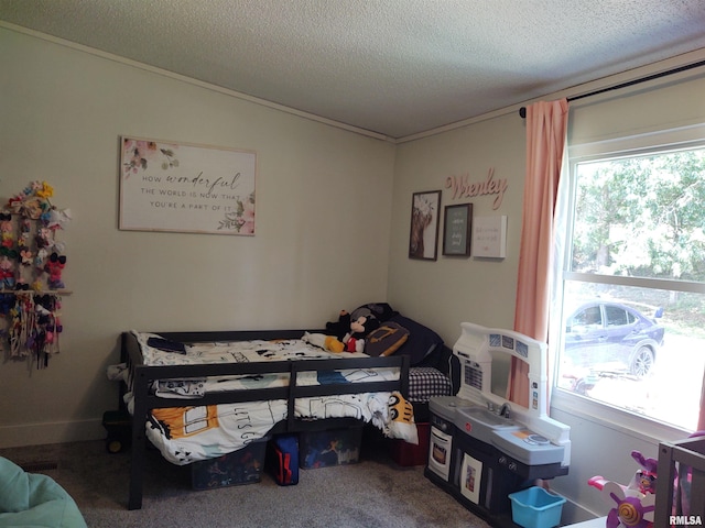 carpeted bedroom featuring a textured ceiling