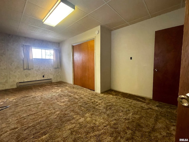 interior space with carpet floors, a baseboard heating unit, and a closet