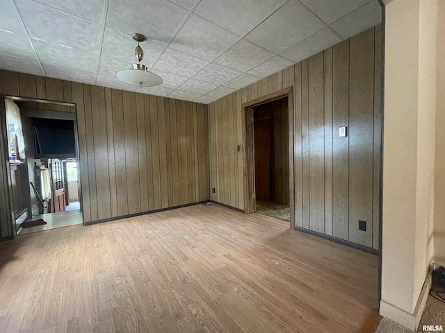 spare room with wooden walls and hardwood / wood-style floors