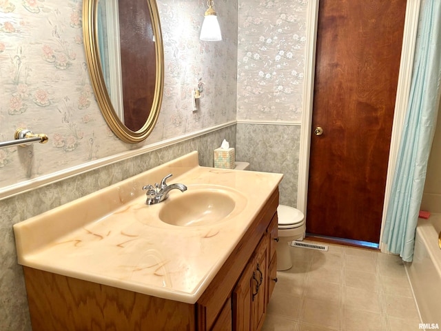 full bathroom featuring vanity, shower with separate bathtub, and toilet