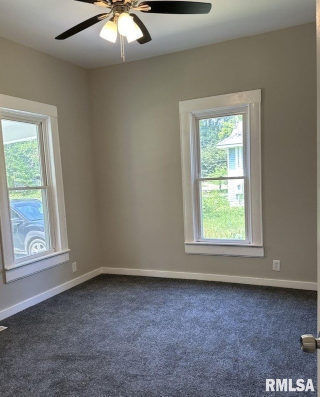 carpeted empty room featuring a wealth of natural light and ceiling fan