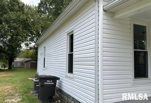 view of home's exterior with a yard and central AC unit