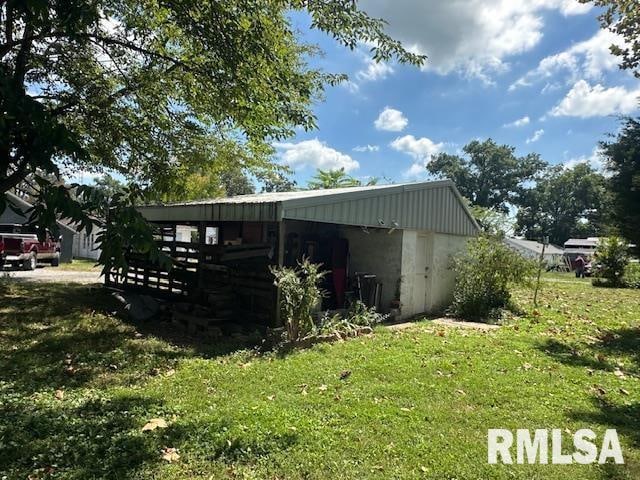 view of outbuilding featuring a lawn