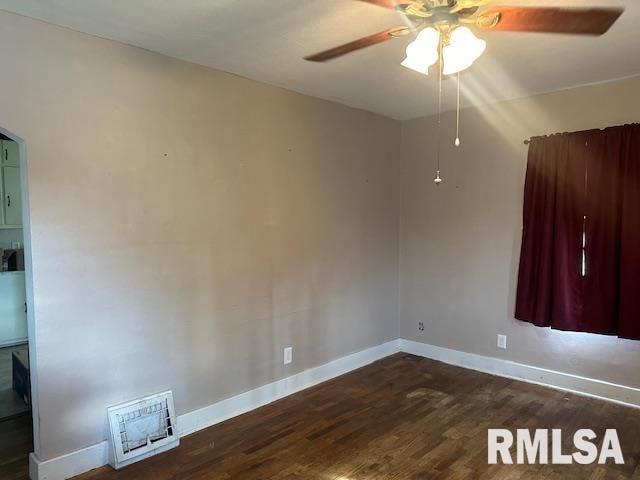 spare room with ceiling fan and dark hardwood / wood-style floors