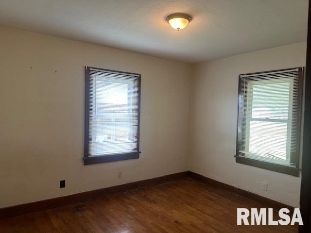 empty room with dark hardwood / wood-style floors