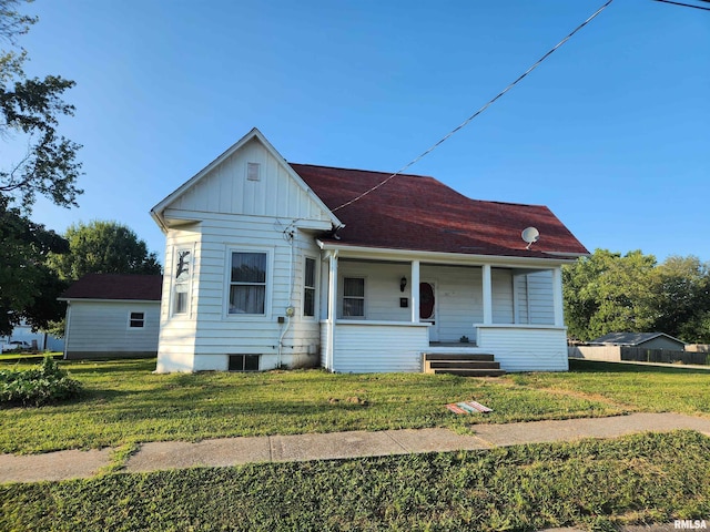 view of front of property featuring board and batten siding, a porch, and a front lawn