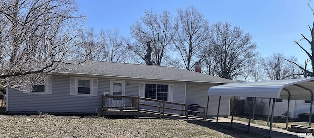 view of front facade featuring a carport, a wooden deck, driveway, and a chimney