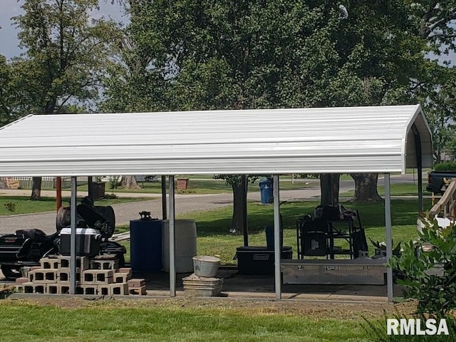 view of vehicle parking featuring a carport and a lawn