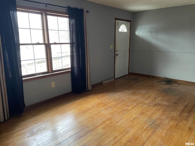 foyer entrance with baseboards and light wood finished floors