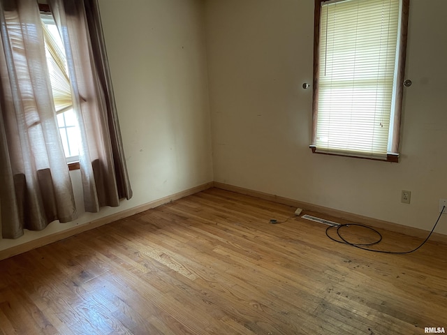 unfurnished room with a healthy amount of sunlight and light wood-type flooring