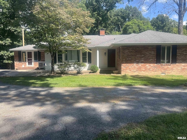 ranch-style house with a front lawn